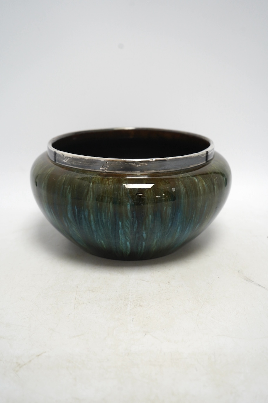 A Christopher Dresser for Linthorpe pottery bowl, silver rimmed, stamped to the base, 24cm in diameter. Condition - good